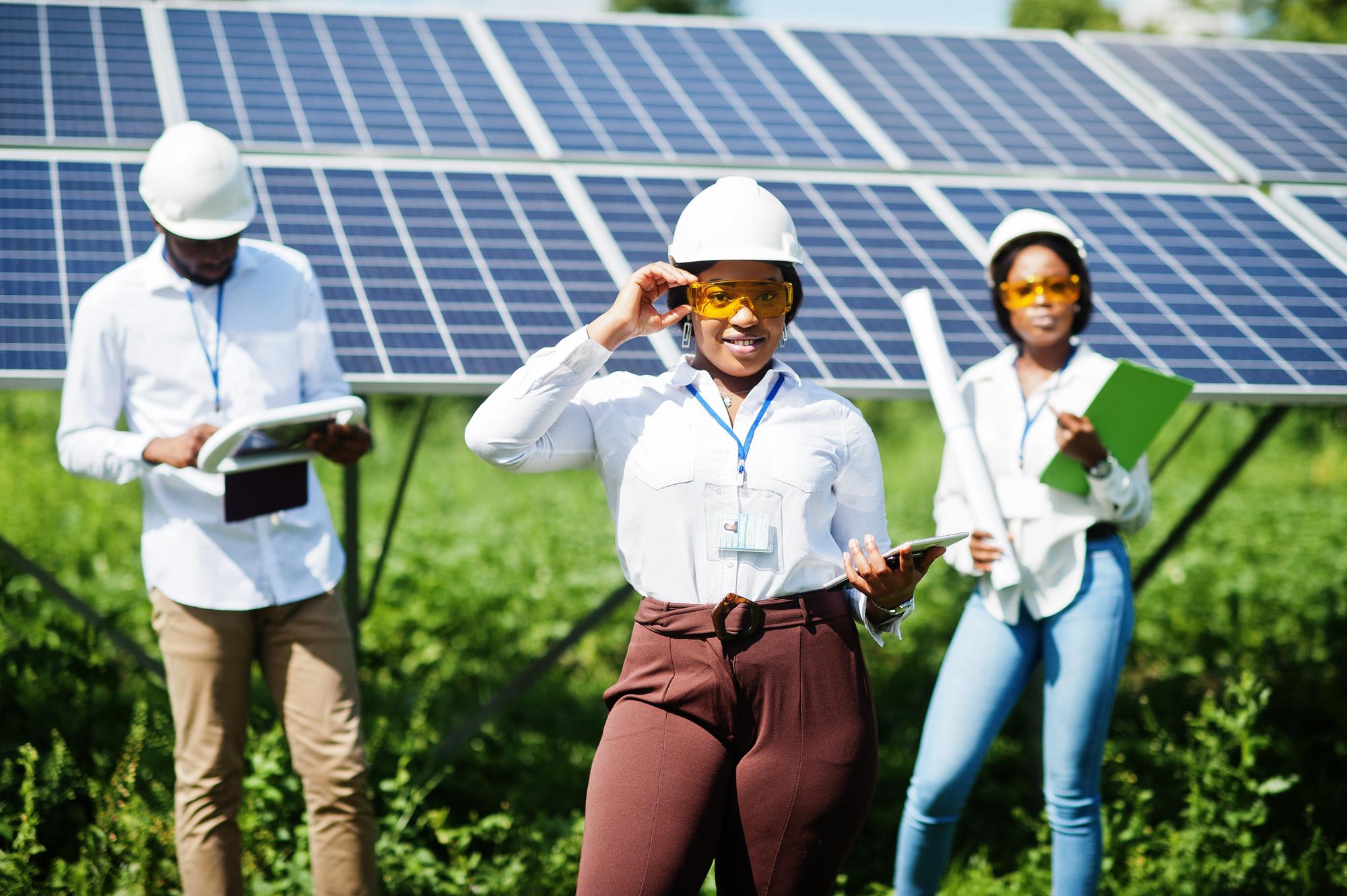 african-american-technician-checks-maintenance-solar-panels-group-three-black-engineers-meeting-solar-station (1)