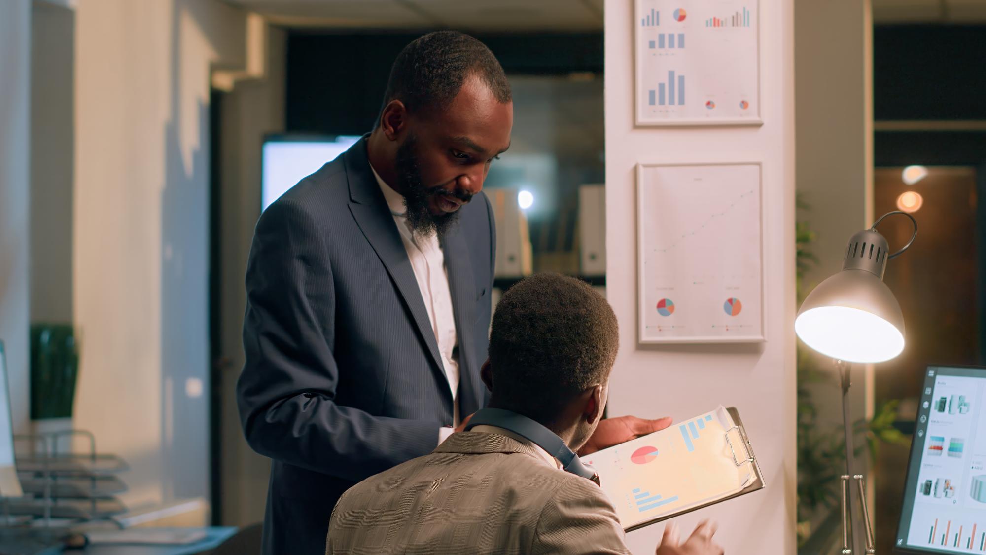 office-manager-interrupting-distracted-worker-listening-music-while-checking-statistical-graphs-show-him-mistake-he-needs-fix-supervisor-analyzing-project-performance-with-employee